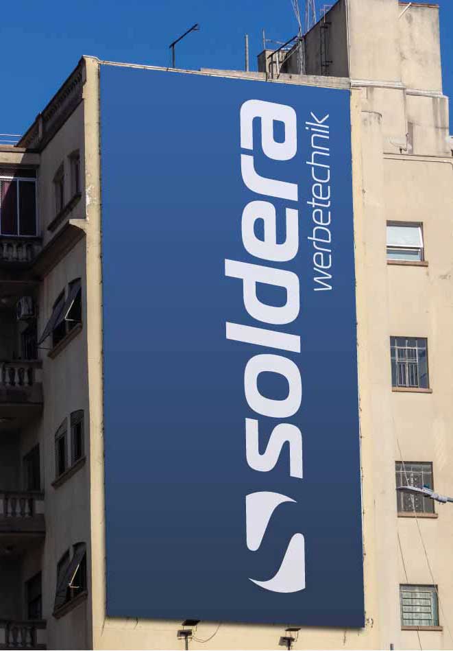 Werbebanner an einer Hauswand mit der Aufschrift Soldera Werbetechnik